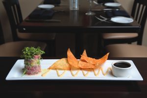 The ahi tower arrives with fried tortilla wedges.