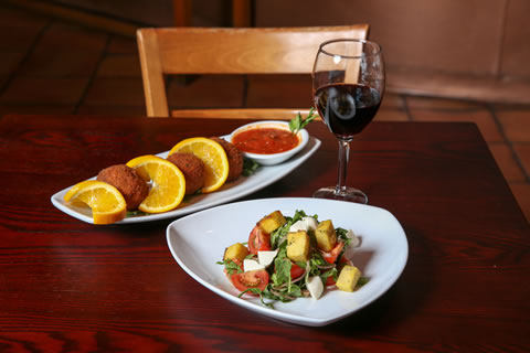 The arancini di riso (back) is perfect for sharing, while the panzanella can double as a starter or entree.